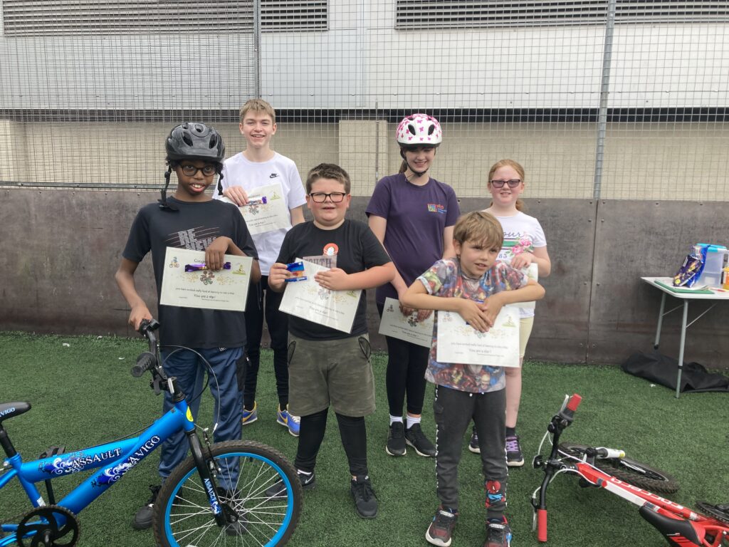 Children with their certificates after completing the bike club.