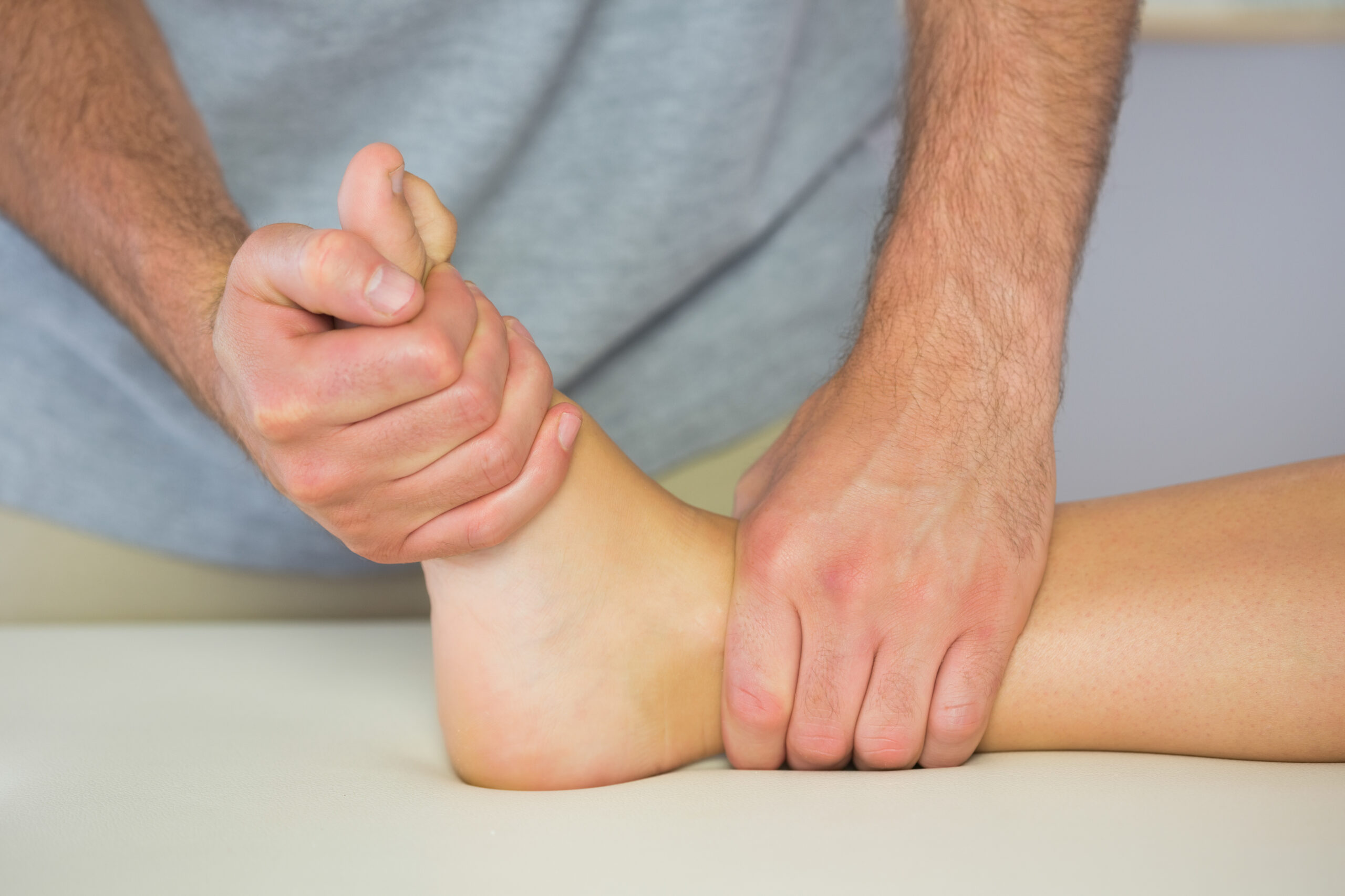 Physio providing treatment to ankle. Link to foot and ankle service.