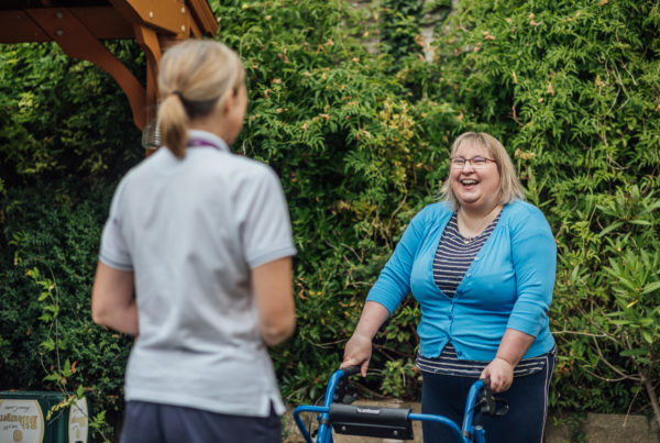 Stroke patient in garden with team member