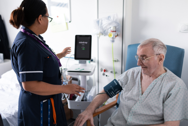 stroke ward photo. Clinician with man.