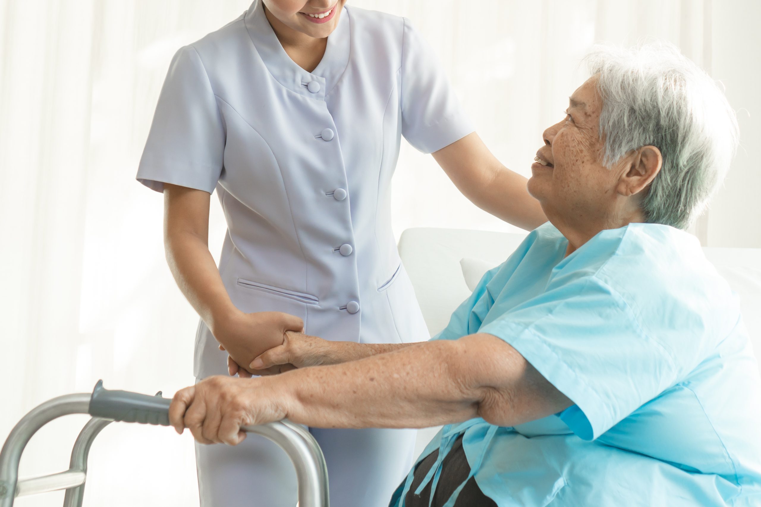 Clinician helping woman with clutches.