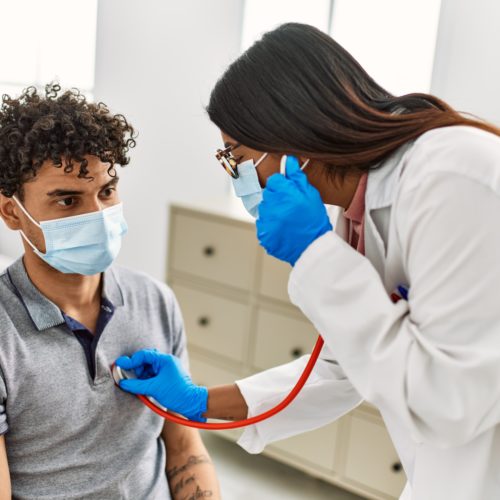 Clinician using stethoscope on patient.