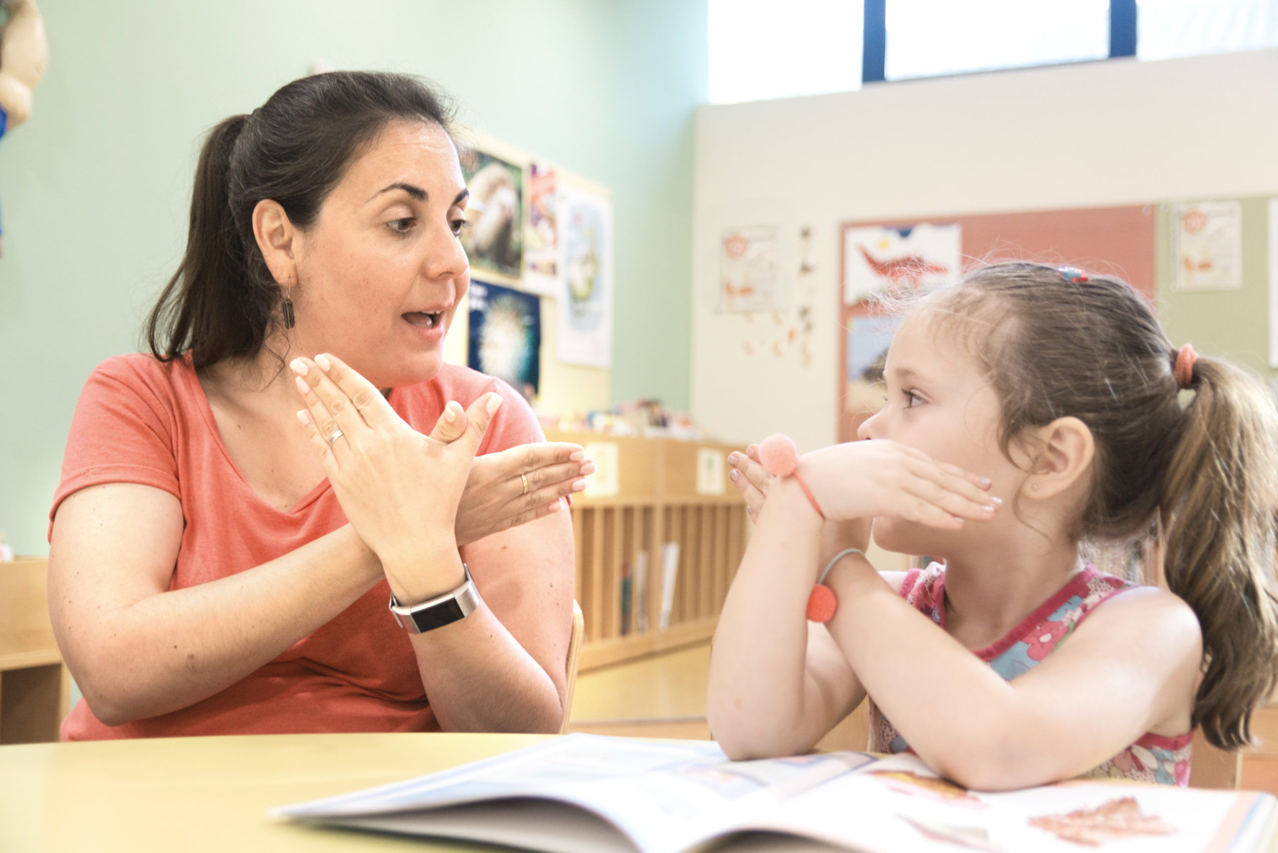 Woman signing with young girl