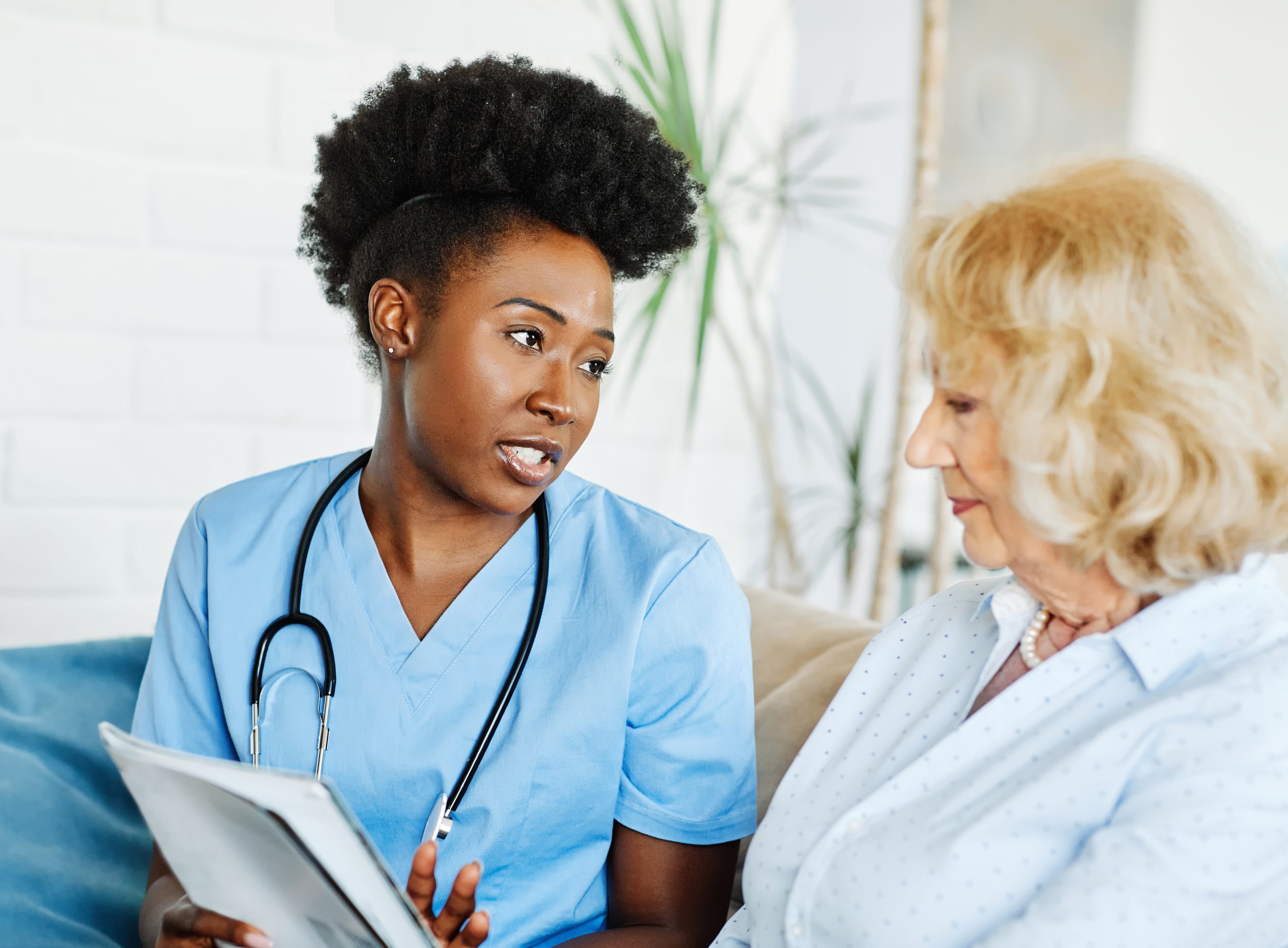 Clinician explaining leaflet to woman.