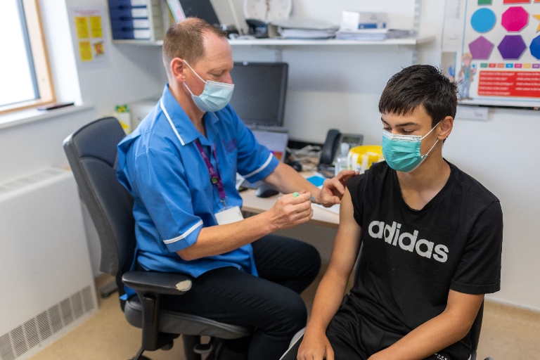 Teenage boy receiving HPV vaccine.