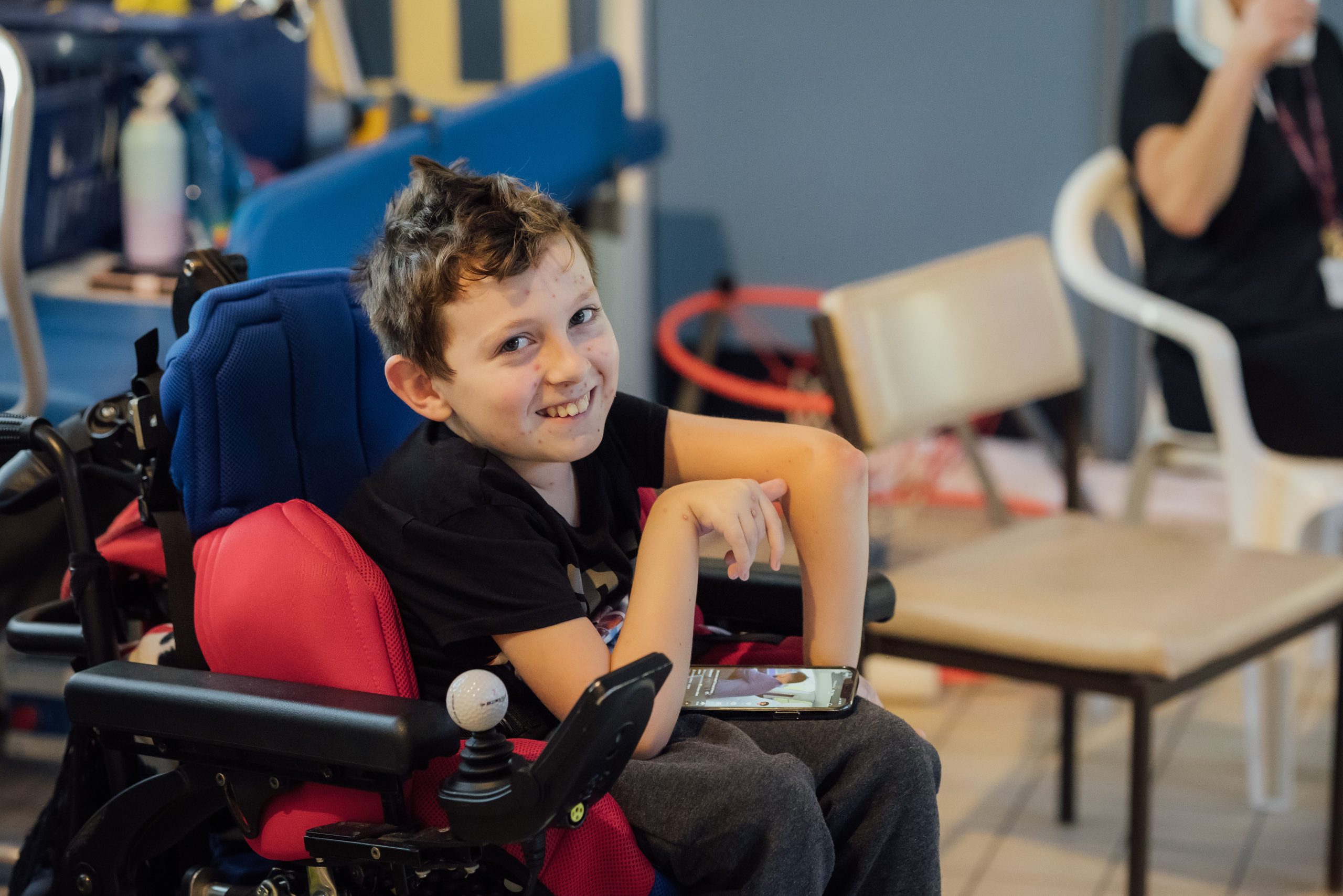 Young boy in a mobility chair.