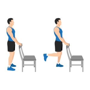 A person stands upright beside a chair for support and bends one knee, bringing the foot up behind to hold the ankle, demonstrating a standing quadriceps stretch.